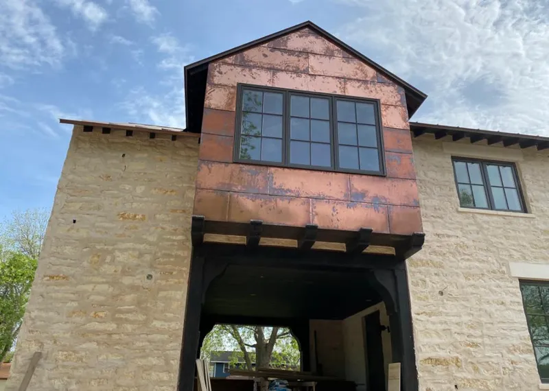 Copper metal panel facade on a stone building for Skylight Installation in Elburn